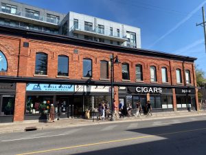 A recent apartment redevelopment at the corner of Bank Street and Fifth Avenue preserved a block of heritage storefronts. Photo by Laura Byrne Paquet.